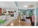 View of a living room flowing into the dining area and kitchen, with an open concept and hardwood floors at 5520 N Kings Hwy., Myrtle Beach, SC 29577