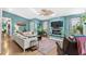 Cozy living room with a fireplace, shiplap accent wall, and lots of natural light and greenery at 5520 N Kings Hwy., Myrtle Beach, SC 29577