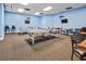 Spacious game room with ping pong tables, chairs, and mounted TVs for entertainment at 5905 South Kings Hwy. # 4309, Myrtle Beach, SC 29575