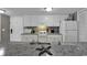 Well-lit kitchen with white cabinetry and appliances featuring a speckled countertop at 5905 South Kings Hwy. # 4309, Myrtle Beach, SC 29575