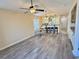 Open-concept living room featuring hardwood floors, modern ceiling fan, and a view of the kitchen at 635 Waterway Village Blvd. # 12-I, Myrtle Beach, SC 29579