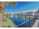 Scenic view of pond and community buildings featuring mature trees, sidewalks, and meticulous landscaping at 635 Waterway Village Blvd. # 12-I, Myrtle Beach, SC 29579