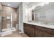 Modern bathroom featuring a dual vanity, a spacious shower with glass door, and tiled floors at 6614 Torino Lane, Myrtle Beach, SC 29572