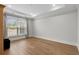 Bright bedroom featuring hardwood floors, neutral walls, and natural light from the window at 6614 Torino Lane, Myrtle Beach, SC 29572