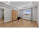 Spacious bedroom with a tray ceiling, wood floors, and a large window offering plenty of natural light at 6614 Torino Lane, Myrtle Beach, SC 29572