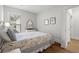 Bright bedroom with white furniture and wood flooring at 6614 Torino Lane, Myrtle Beach, SC 29572