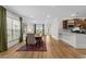 Open-concept dining area with wood floors, and modern lighting fixture at 6614 Torino Lane, Myrtle Beach, SC 29572