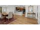 Dining room featuring wood floors and a view into the modern kitchen at 6614 Torino Lane, Myrtle Beach, SC 29572