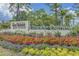 Beautiful community entrance sign with colorful flowers and lush landscaping at 6614 Torino Lane, Myrtle Beach, SC 29572