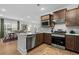 Well-lit kitchen showcasing stainless steel appliances and a breakfast bar with views to the dining room at 6614 Torino Lane, Myrtle Beach, SC 29572