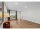 Bright living room with wood floors, neutral walls, and a large window with scenic backyard views at 6614 Torino Lane, Myrtle Beach, SC 29572