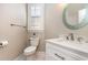 Stylish powder room features a round mirror, marble countertop sink, and window with shutters at 78 Oakmont Dr., Pawleys Island, SC 29585