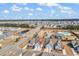 Extensive aerial view showcasing a community with townhomes, water features, and a pool under a blue sky at 801 San Marco Ct. # C, Myrtle Beach, SC 29579