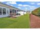 A well-maintained backyard features a screened porch and lush green grass at 801 San Marco Ct. # C, Myrtle Beach, SC 29579