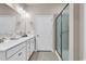 Bright bathroom boasts double sinks, white cabinets, a glass shower, and modern fixtures at 801 San Marco Ct. # C, Myrtle Beach, SC 29579