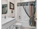 Well-lit bathroom with a vanity, toilet, and a shower/tub combo with a decorative curtain at 801 San Marco Ct. # C, Myrtle Beach, SC 29579