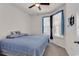 Cozy bedroom featuring a comfortable bed, ceiling fan, and bright windows with decorative curtains at 801 San Marco Ct. # C, Myrtle Beach, SC 29579