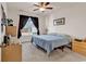 Comfortable bedroom features a bed, ceiling fan, dark curtains, and a window offering plenty of natural light at 801 San Marco Ct. # C, Myrtle Beach, SC 29579