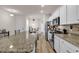 Bright kitchen with white cabinets, granite countertops, and modern stainless steel appliances at 801 San Marco Ct. # C, Myrtle Beach, SC 29579
