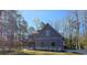Side view of a craftsman-style home features a covered porch and attractive stone accents at 8012 Old Reaves Ferry Rd., Conway, SC 29526