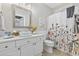 Bathroom vanity featuring decorative mirror and a floral shower curtain at 805 Sunswept Ct. # 102, Murrells Inlet, SC 29576