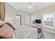 Bedroom featuring a ceiling fan, window, and attached bathroom at 805 Sunswept Ct. # 102, Murrells Inlet, SC 29576