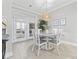 Bright dining area with French doors, a round table, and neutral decor, creating an inviting space at 805 Sunswept Ct. # 102, Murrells Inlet, SC 29576