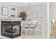 Cozy dining area features a fireplace and a round table with white chairs, perfect for intimate meals at 805 Sunswept Ct. # 102, Murrells Inlet, SC 29576