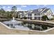 Beautiful condominium exteriors with screened porches overlooking serene pond with fountain at 805 Sunswept Ct. # 102, Murrells Inlet, SC 29576