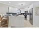 Well-lit kitchen features white cabinets, stainless steel appliances, a bar, and granite countertops at 805 Sunswept Ct. # 102, Murrells Inlet, SC 29576