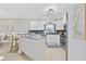 Modern kitchen with white cabinets, granite countertops, stainless steel appliances, and stylish backsplash at 805 Sunswept Ct. # 102, Murrells Inlet, SC 29576