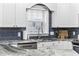 Close-up of the kitchen area, featuring granite countertops, stainless steel appliances, and white cabinets at 805 Sunswept Ct. # 102, Murrells Inlet, SC 29576