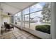 Enclosed sunroom with tile flooring and views of the water feature and community at 805 Sunswept Ct. # 102, Murrells Inlet, SC 29576