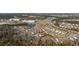 Aerial view of a residential area showcasing homes near a lake and shopping center at 834 Summer Starling Pl., Myrtle Beach, SC 29577