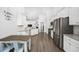 Modern kitchen featuring white cabinets, stainless steel appliances, and a breakfast table with seating at 834 Summer Starling Pl., Myrtle Beach, SC 29577