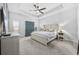 Bright main bedroom with a tray ceiling, coastal decor, and a large wooden bed at 834 Summer Starling Pl., Myrtle Beach, SC 29577