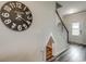 Foyer with wood-look flooring, staircase with a small pet nook and a decorative clock on the wall at 891 Agostino Dr., Myrtle Beach, SC 29579