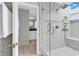 Elegant bathroom with a glass-enclosed shower, and an open doorway to a white vanity at 994 Debordieu Blvd., Georgetown, SC 29440