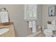 Neutral bathroom with patterned wallpaper, shuttered window, a sink with granite countertop, and matching decor at 994 Debordieu Blvd., Georgetown, SC 29440