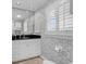 Elegant bathroom featuring patterned wallpaper, a granite countertop, and a window with shutters at 994 Debordieu Blvd., Georgetown, SC 29440