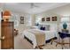 Bright bedroom with neutral tones, a ceiling fan, shuttered windows, and coastal decor at 994 Debordieu Blvd., Georgetown, SC 29440