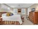Spacious bedroom with a king-size bed, shuttered windows, ceiling fan, and classic wooden dresser at 994 Debordieu Blvd., Georgetown, SC 29440