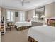 Bedroom featuring twin beds, shuttered windows, a ceiling fan, and neutral decor at 994 Debordieu Blvd., Georgetown, SC 29440