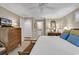 Bright bedroom featuring a ceiling fan, shuttered windows, and a view into an en-suite bathroom at 994 Debordieu Blvd., Georgetown, SC 29440