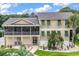 Attractive two-story home with a screened porch and a well-manicured front yard and beautiful walkway at 994 Debordieu Blvd., Georgetown, SC 29440