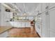 Bright, open kitchen with white cabinets, granite countertops, modern appliances, and hardwood floors at 994 Debordieu Blvd., Georgetown, SC 29440