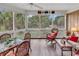 Enjoy nature in this screened porch, furnished with comfortable seating and a dining area at 994 Debordieu Blvd., Georgetown, SC 29440