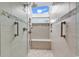 Luxurious tiled shower with skylight, bench seating, and decorative mosaic accents at 994 Debordieu Blvd., Georgetown, SC 29440
