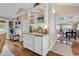 Stylish wet bar area with glass display cabinets, stone backsplash, and under-counter refrigerator at 994 Debordieu Blvd., Georgetown, SC 29440