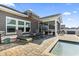 Backyard with an in-ground pool, lounge chairs, and a screened-in porch at 1047 Harbison Circle, Myrtle Beach, SC 29579